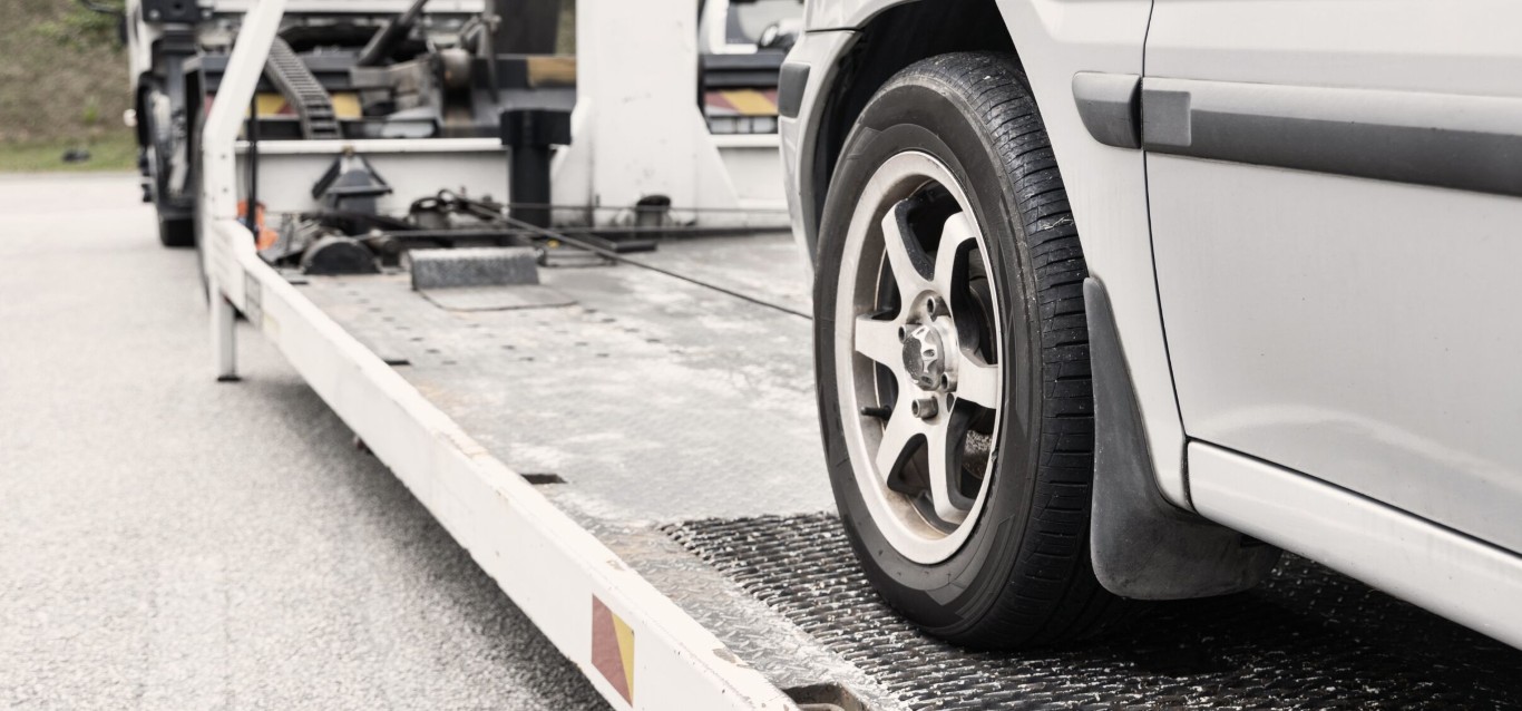 Flatbed towing service safely transporting vehicle in Beavercreek, OH area